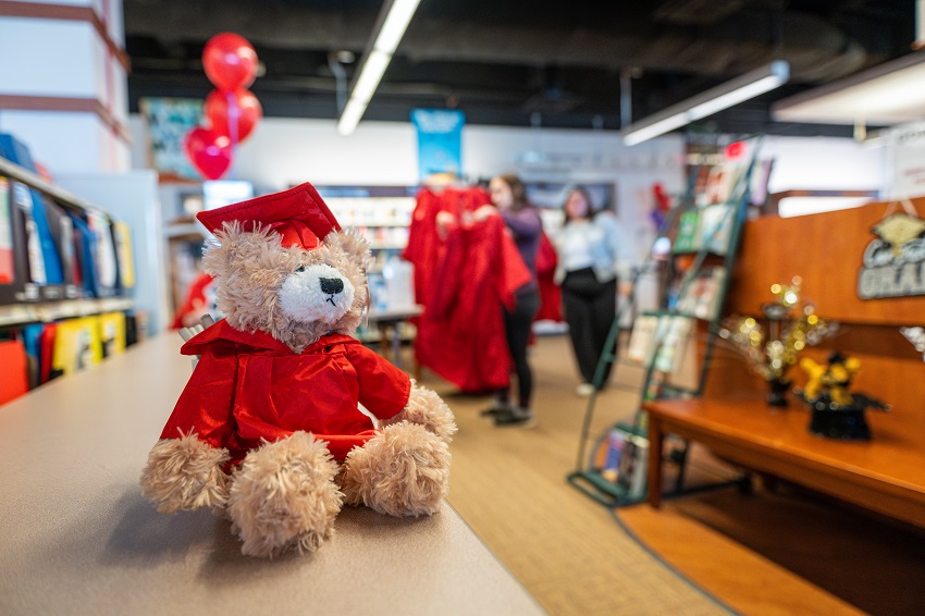 teddy bear wearing an SVSU cap and gown at the SVSU Bookstore